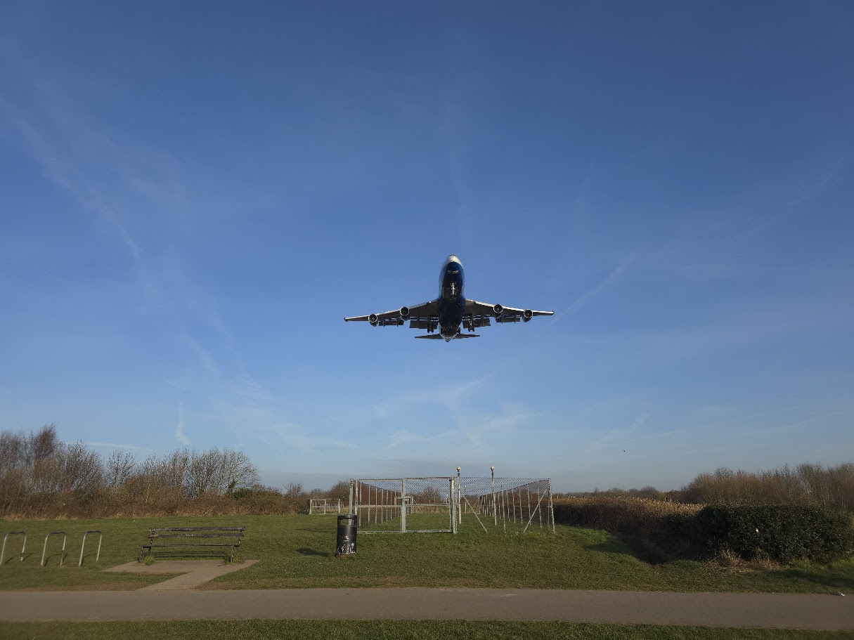 Commercial aircraft on approach over Sheldon from below